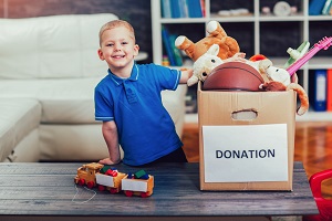 Young boy with box of toy donations